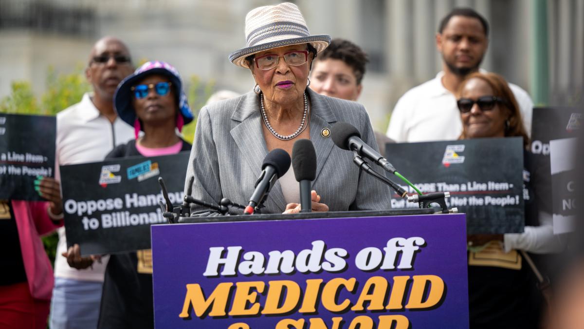 Rep. Adams at a podium for a Hands off Medicaid & SNAP rally