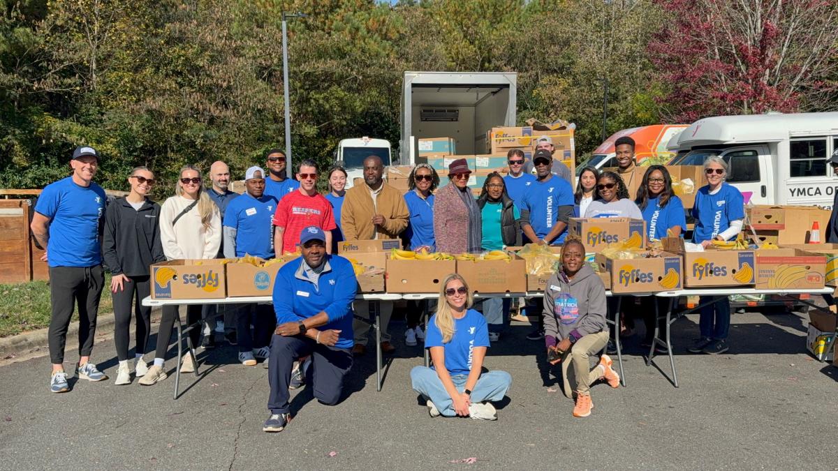 Rep. Adams outside with food bank volunteers