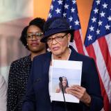 Rep Adams with a photo of Kira Johnson