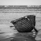 A solitary helmet remains on the battlefield beaches of Normandy
