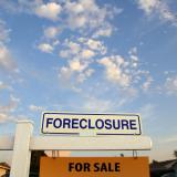 foreclosure sign in front of a house