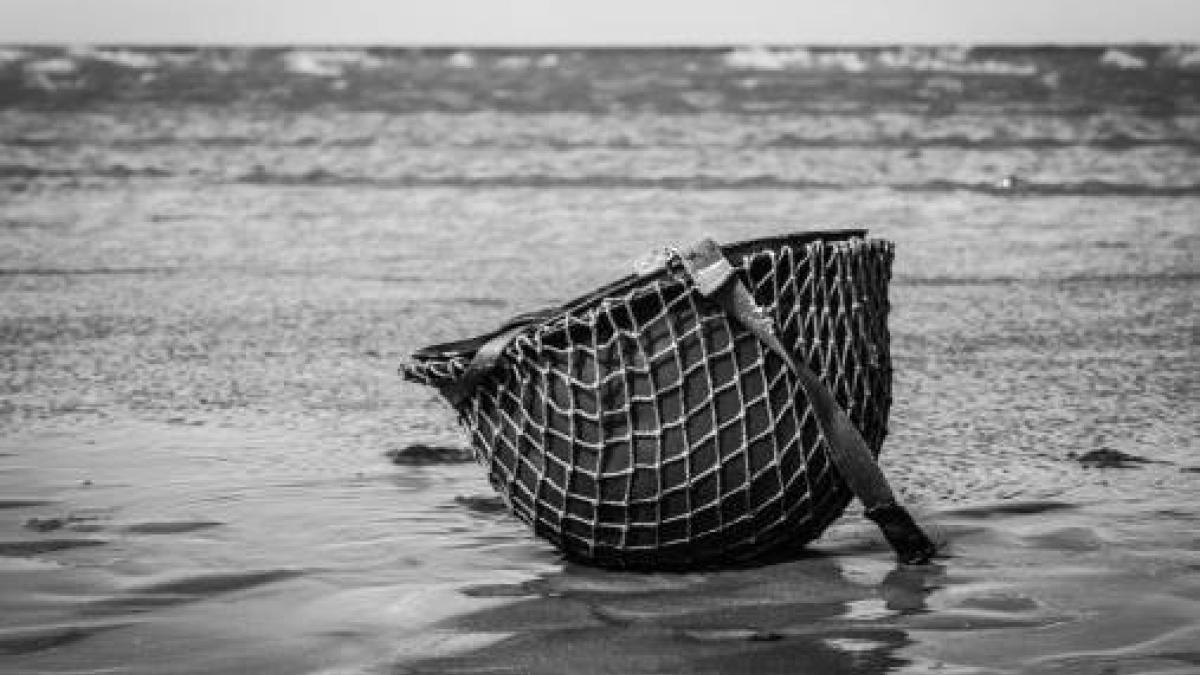 A solitary helmet remains on the battlefield beaches of Normandy