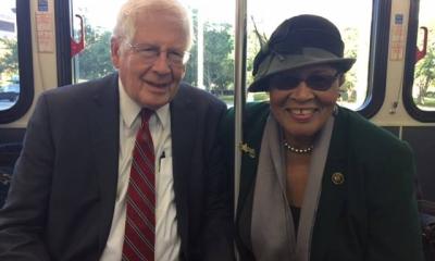 Rep. Alma Adams and Rep. David Price sitting together and smiling on a CATS bus in Charlotte